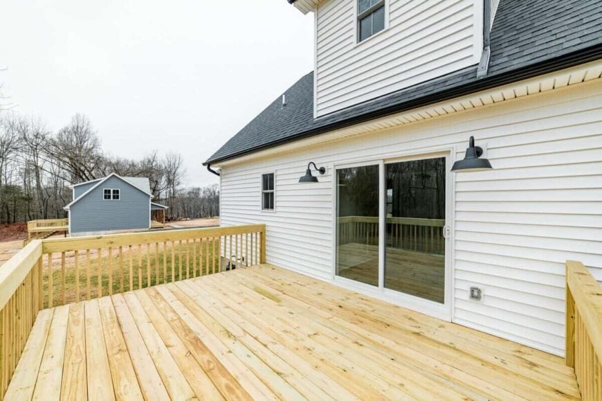 Spacious sun deck with wide plank flooring and matching wooden railings.