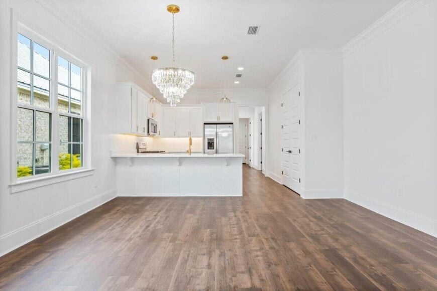 Dining space with a large window and a cascading crystal chandelier that adds elegance to the area.