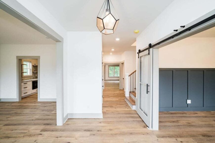 Foyer with a stylish pendant light flanked by the formal dining room and study.