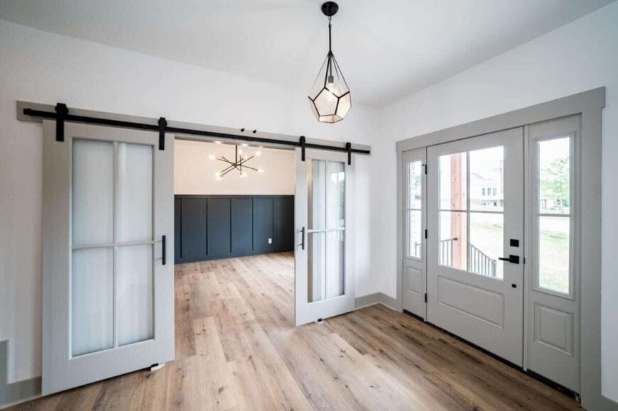 Double sliding barn doors in the foyer reveal the study.