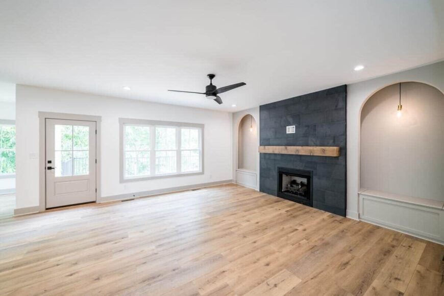A dark brick fireplace nestled between the arched insets sets an interesting focal point to the family room.