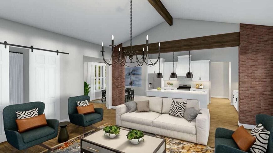 The great room has green wingback chairs and a beige sofa paired with a console table.