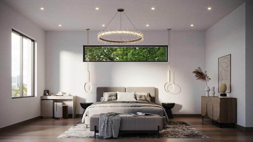 The primary bedroom has a hardwood floor and pristine white walls adorned with abstract artwork and modern, round lighting fixtures.