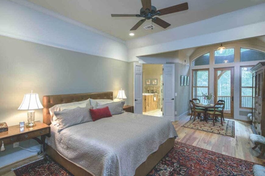 The primary bedroom features a spacious sitting area and private porch access through a glazed door.