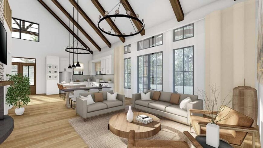 A cathedral ceiling with exposed beams crowns the open living space shared by the great room, dining area, and kitchen.