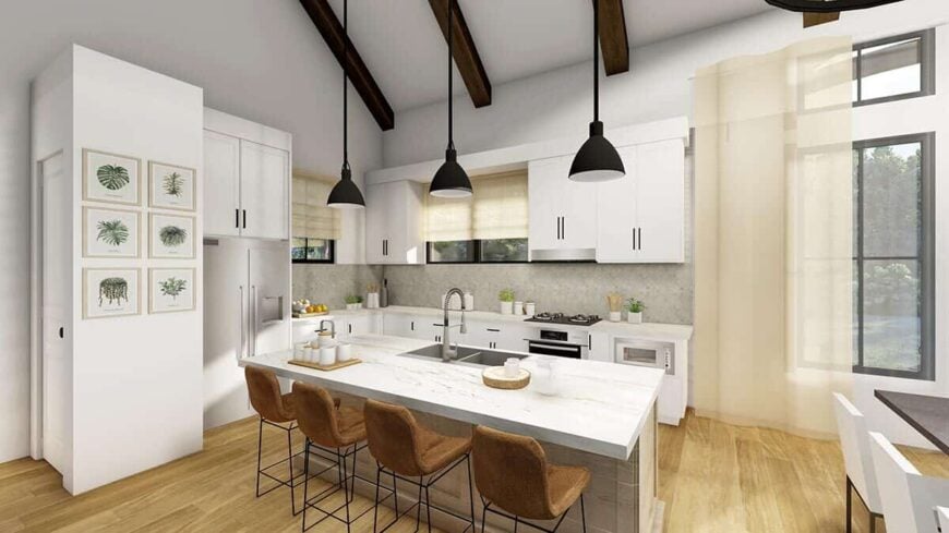 The kitchen features white cabinets, slate appliances, and a breakfast island fitted with double sinks.