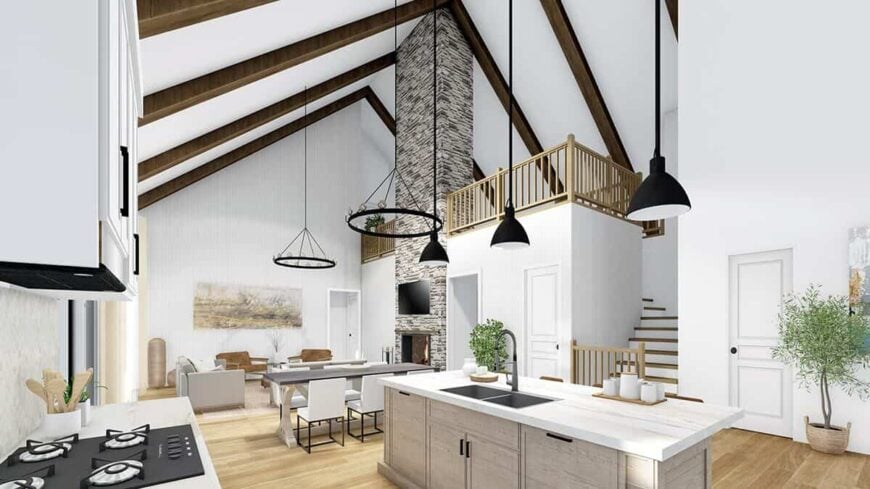 A staircase off the living space leads to the loft bordered by wooden railings.
