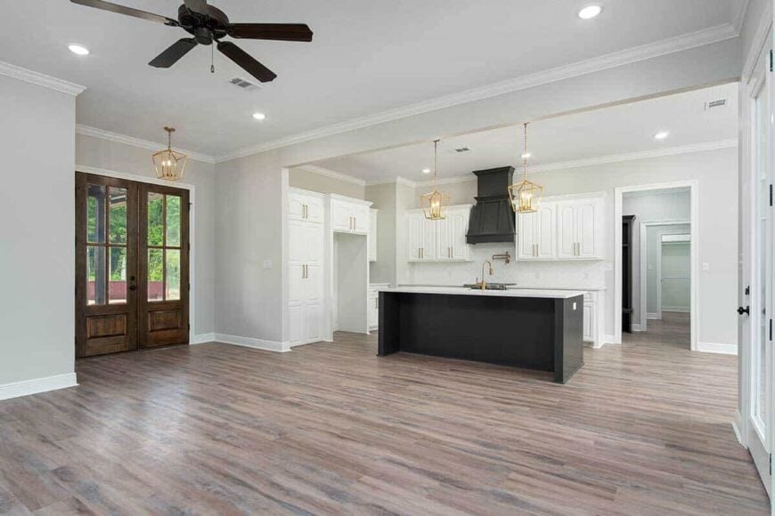An open layout view of the great room and kitchen under a white regular ceiling.