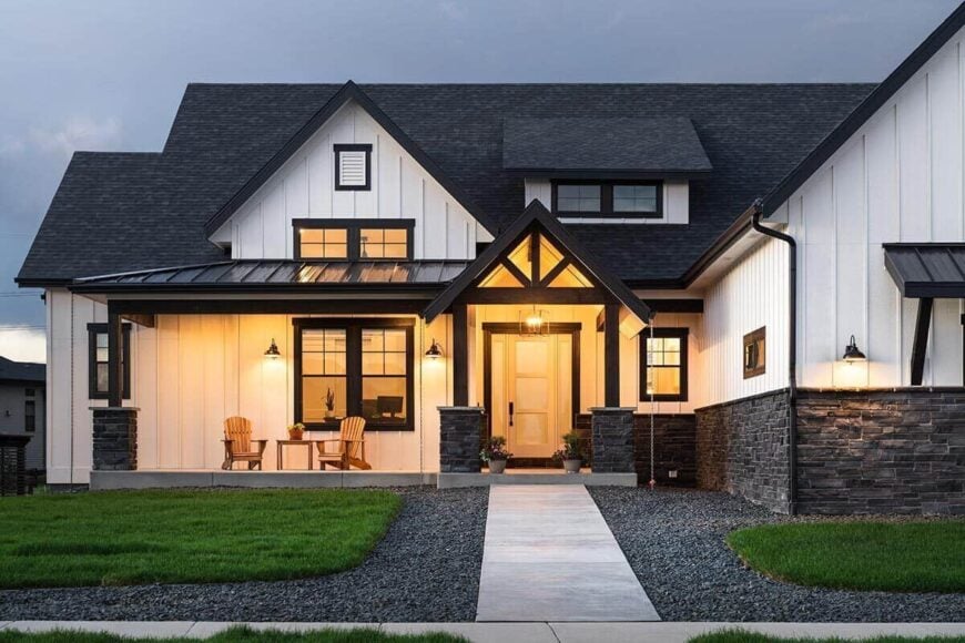 Home entry with metal and gable roofs supported by tapered columns. It is topped with another gable and a shed dormer.