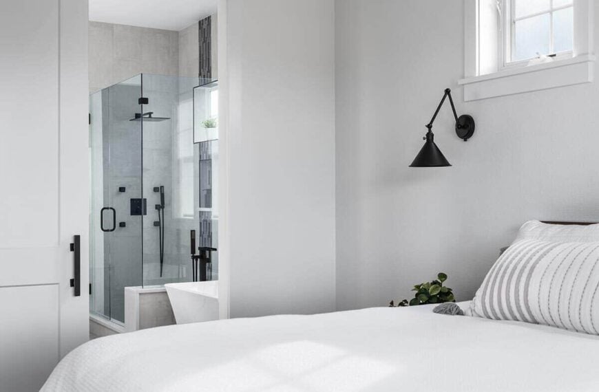 Primary bedroom with a private bathroom and windows that allow natural light in.