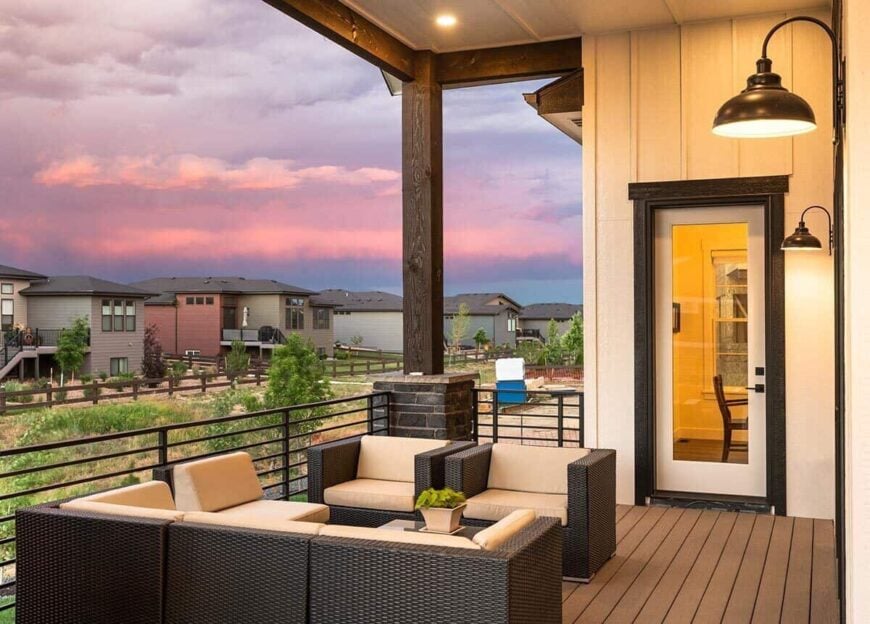 The covered deck is furnished with cushioned wicker seats and a matching coffee table.