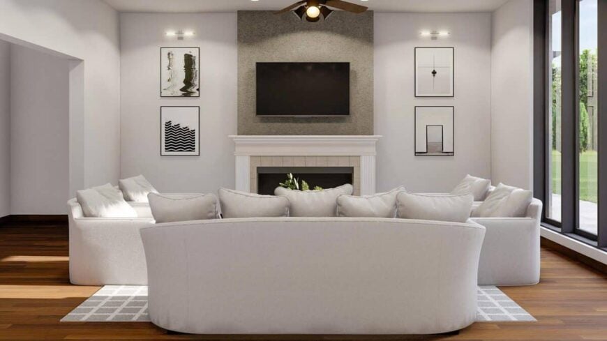 Great room with modern sofas, a TV above the fireplace, and minimalist artworks adorning the white walls.