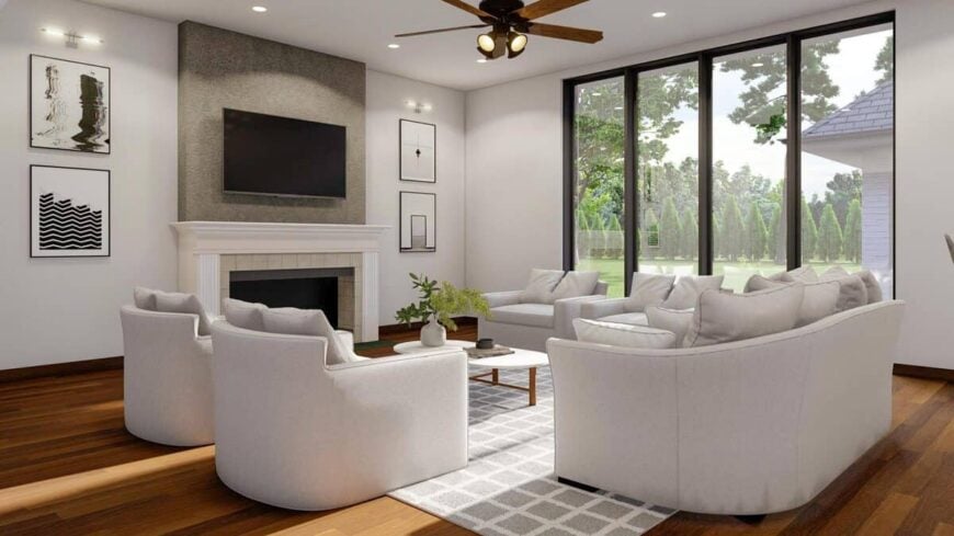 The great room includes large windows overlooking the backyard.
