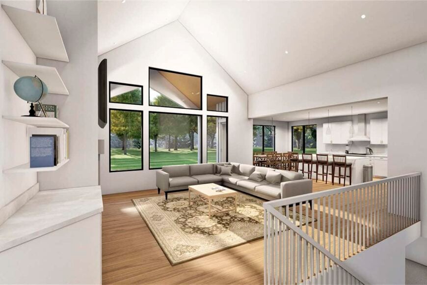 An open layout view of the bright great room, kitchen, and dining area.