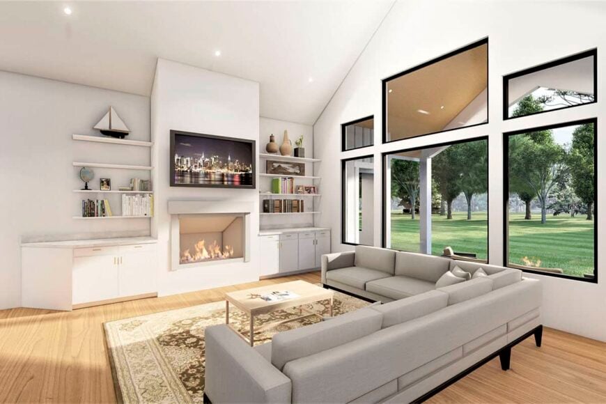 The great room includes a vaulted ceiling, a fireplace, and large windows overlooking the backyard.
