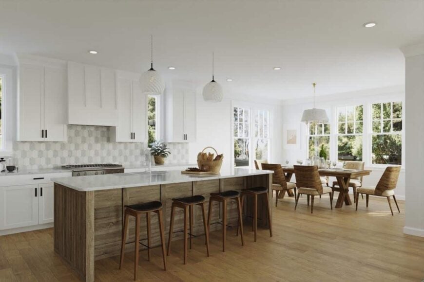 Kitchen with white cabinetry and a rustic center island paired with wooden bar stools.