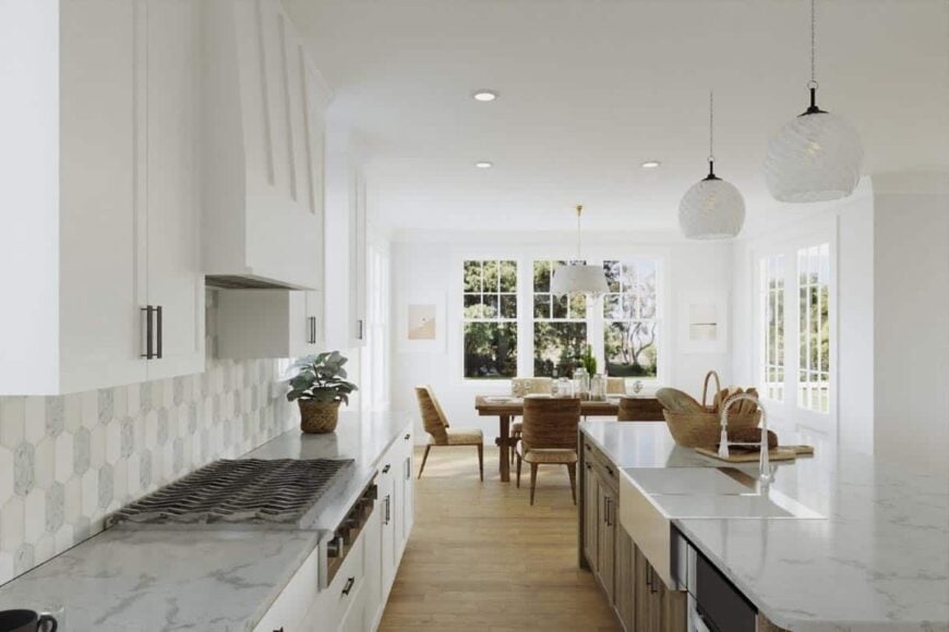 Across the kitchen is the dining area well-lit by surrounding windows.