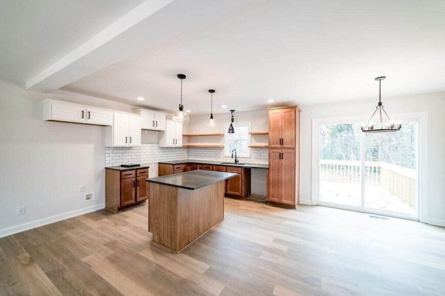Kitchen and dining area with hardwood floor and sliding glass doors that open to the sun deck.