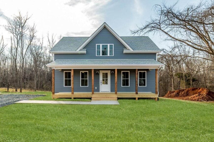 Front exterior view with a large, center gable and a covered porch that spans the length of the house.