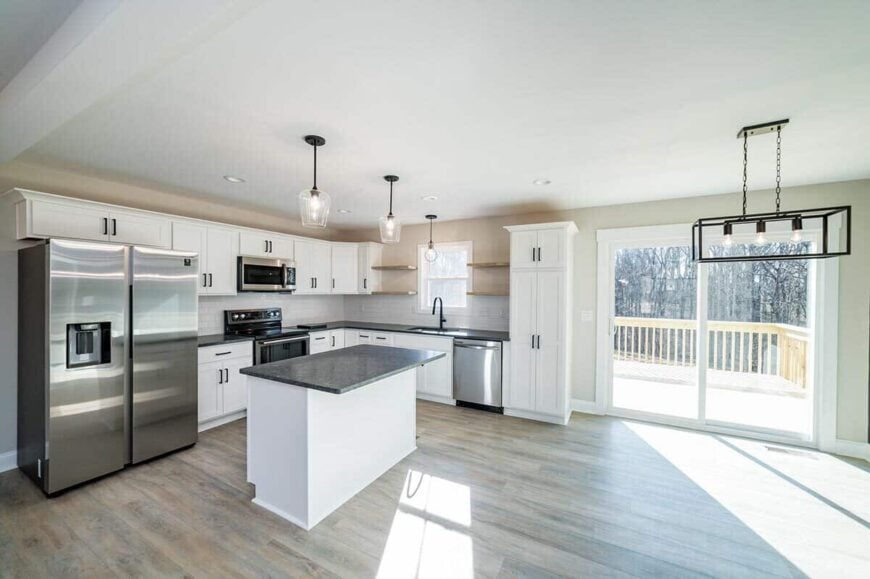 Kitchen and dining area with hardwood flooring and sliding glass doors that open to a spacious deck.