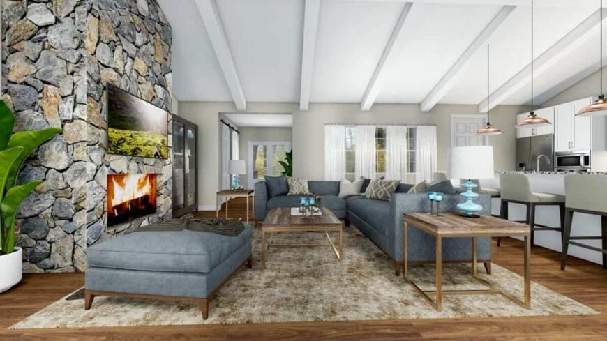 The great room has an L-shaped sofa and a fireplace topped with a wall-mounted TV.