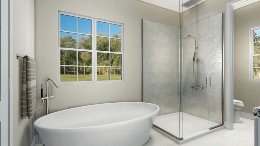 The primary bathroom is equipped with a toilet room, a walk-in shower, and a freestanding tub placed under the window.