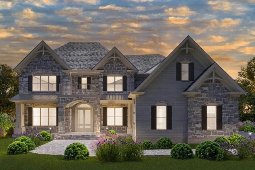 Night rendering of the French country home showcasing its warm glow that complements the beautiful stone exterior.