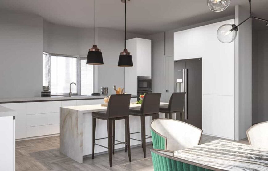 The kitchen is equipped with slate appliances, custom cabinetry, and a waterfall island paired with leather counter chairs.