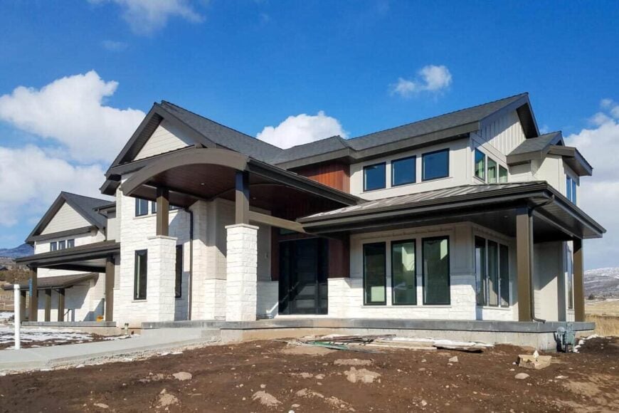 Covered front porch with a barrel-vaulted roof supported by tapered columns.