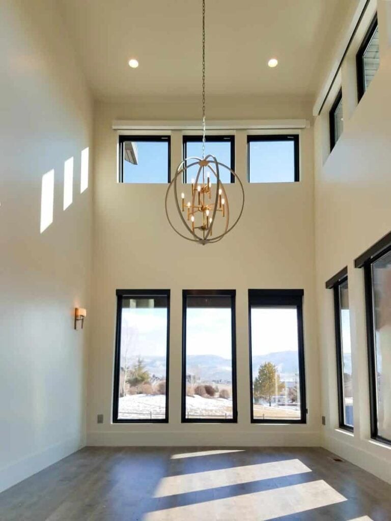 Foyer with a two-story ceiling, clerestory windows, and a spherical chandelier.