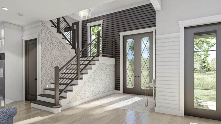 Foyer with a french entry door and a staircase leading to the sleeping quarters.