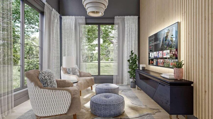Huge windows flood the living room with natural light and a wood slat accent wall adds an interesting character.