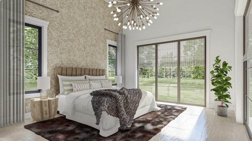 Primary bedroom with polished hardwood flooring and large windows overlooking the backyard.