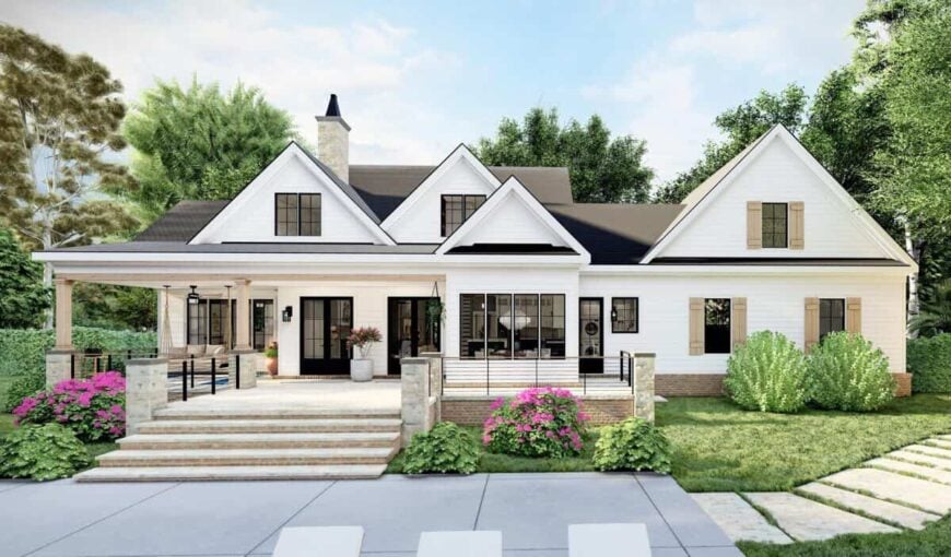 Rear rendering with multiple gables, shuttered windows, and a spacious porch bordered with wrought iron railings.