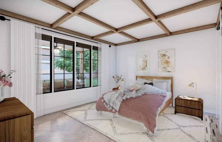 Primary bedroom with a coffered ceiling, wooden furnishings, and a wall of windows dressed in sheer curtains.