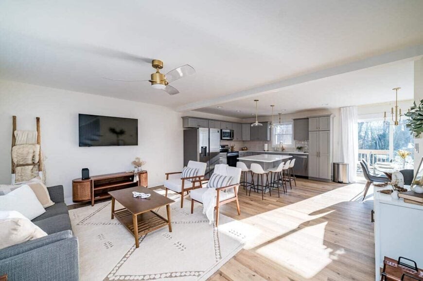 An open layout view of the family room, kitchen, and bright dining area.