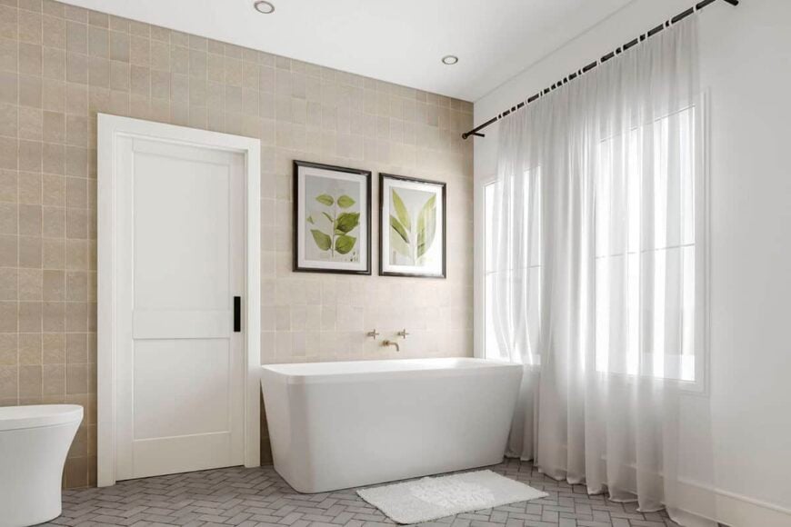 A freestanding bathtub adorned with foliage artworks completes the primary bathroom.
