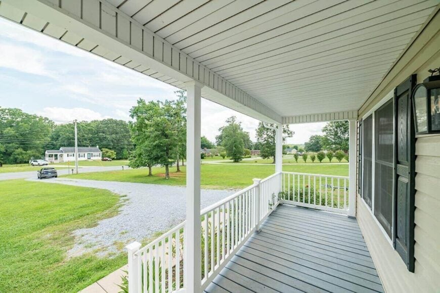 The entry porch has also wide plank flooring and a white paneled ceiling.