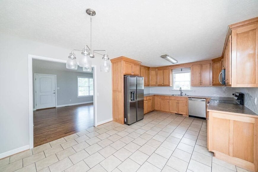 An open doorway separates the living room from the eat-in kitchen.