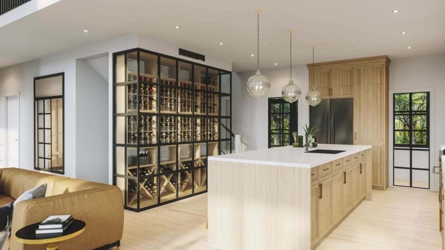 The kitchen features a marble-top island and a wine cellar encased in framed glass panels.