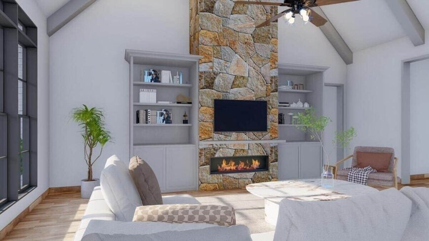 The great room includes built-in cabinets and a stone fireplace topped with a TV.