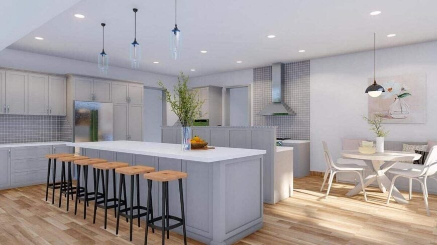 Eat-in kitchen with a lengthy island, gray cabinetry, and a breakfast nook with banquette seating.