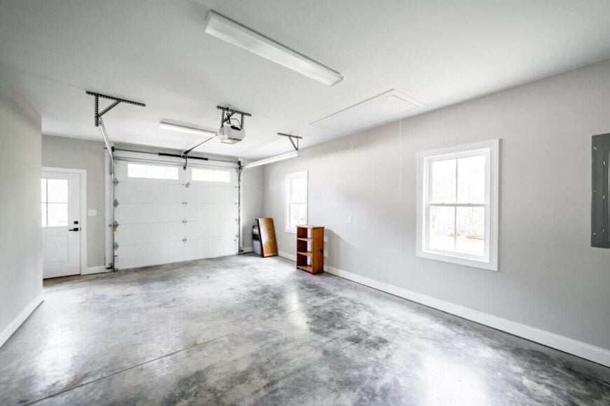 Single garage with concrete flooring and a metal roll-up door.
