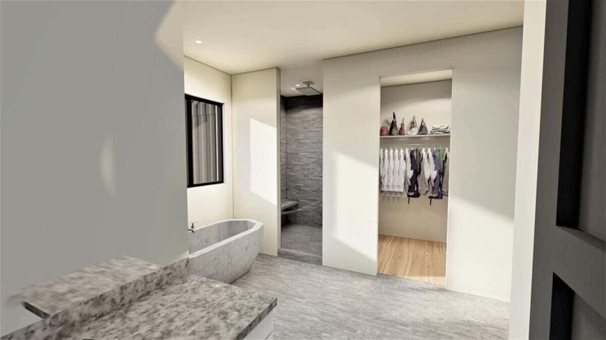 The primary bathroom features a freestanding tub, a shower area, and a walk-in closet.