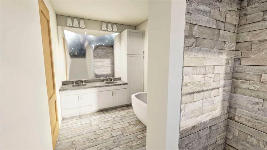 Primary bathroom with a dual sink vanity, a linen closet, and a freestanding tub over tiled flooring.