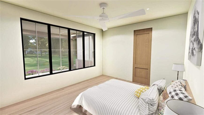 The primary bedroom has a cozy wooden bed and a great view of the expansive yard.