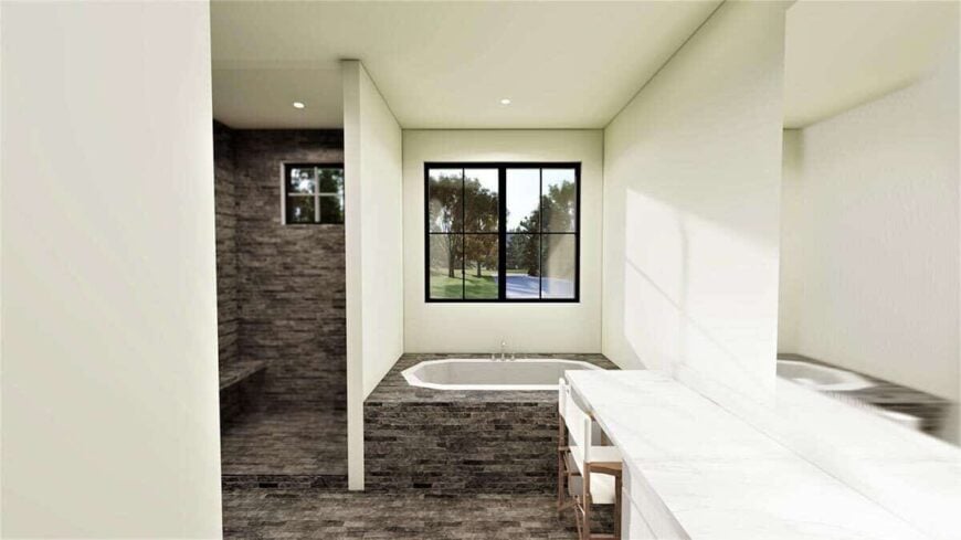 Primary bathroom with a marble-top vanity, a drop-in bathtub, and a walk-in shower with a tiled bench.