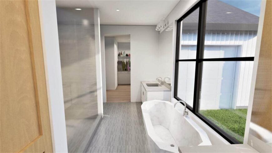 The primary bathroom features a shower area, a walk-in closet, and a freestanding tub with views of the backyard.
