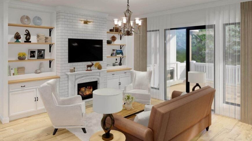 Living room with leather seats, a brick fireplace, and glass sliders that open to the covered porch.