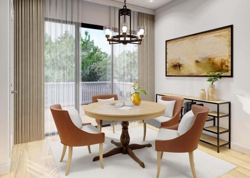 Bright dining area with a round dining set and a metal buffet table adorned with framed artwork.
